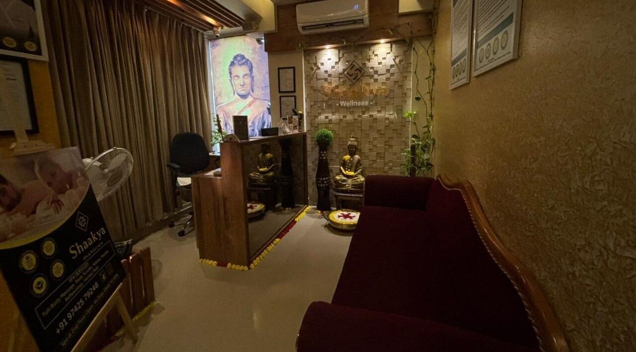 Reception area at Shaakya Spa & Wellness, Bengaluru, Karnataka, IN, featuring serene Buddha decor.