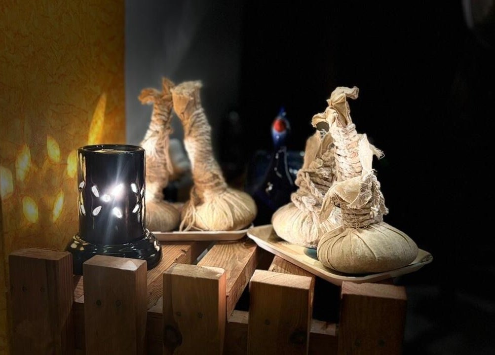 Herbal pouches and candle at Shaakya Spa & Wellness, Bengaluru, Karnataka, IN, create a calming atmosphere.