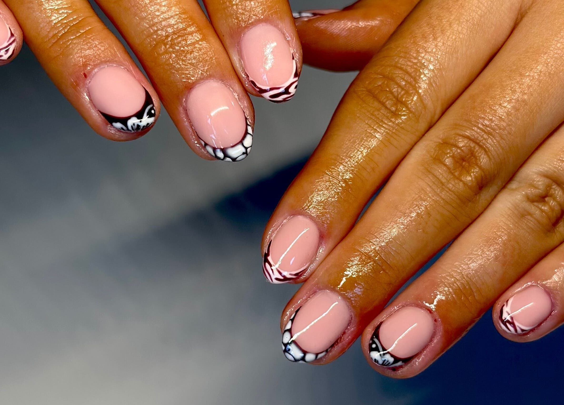 Elegant nail art design at Nails By Lauren in Crawley, England, GB, showcasing glossy pink manicure with black accents.