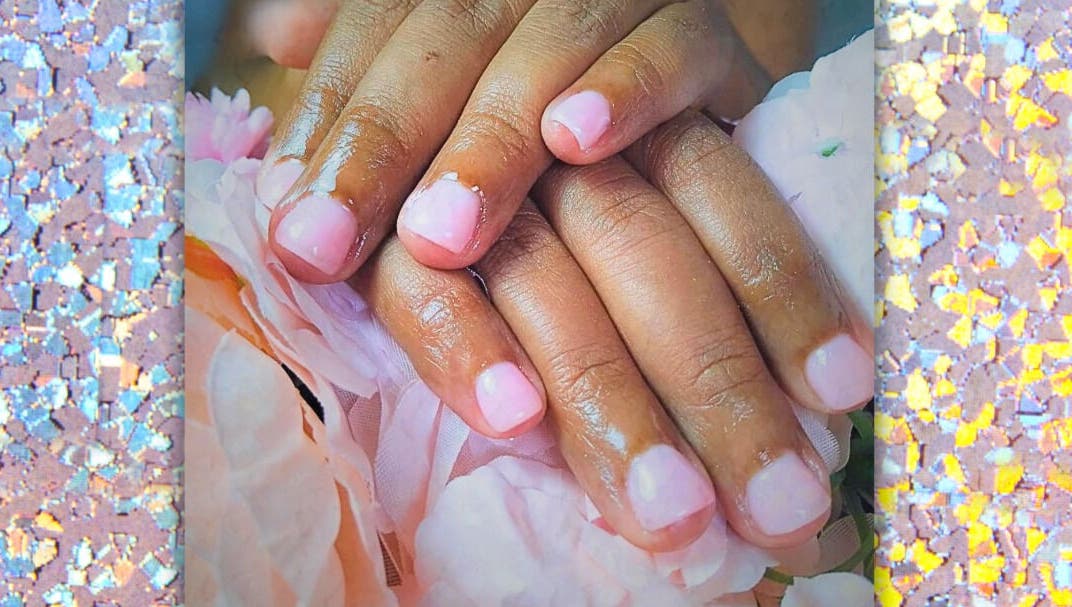 Elegant pink manicure on floral background at Be Still Spa, Roche Caiman, SC.
