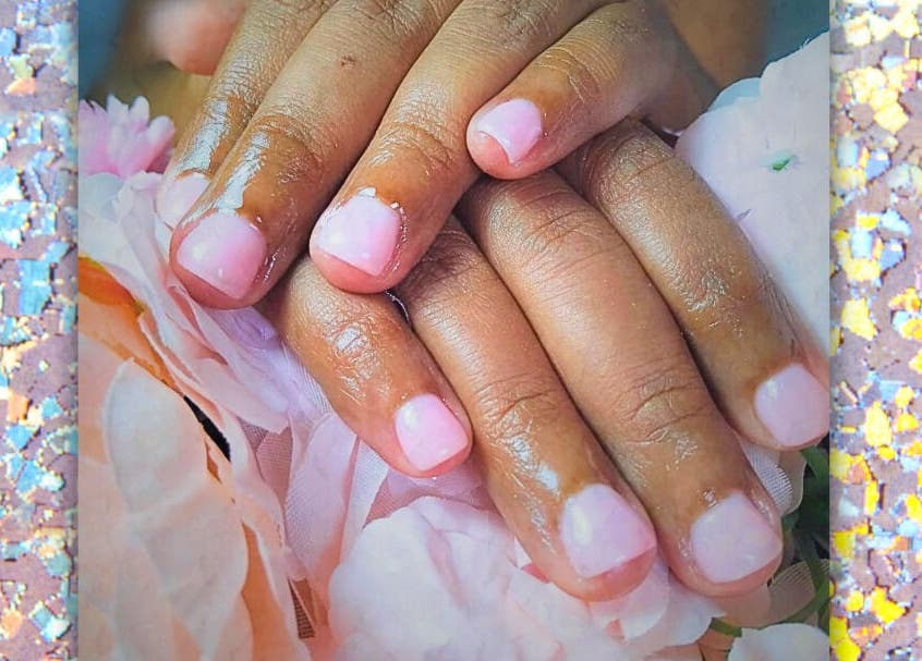 Elegant pink manicure on floral background at Be Still Spa, Roche Caiman, SC.