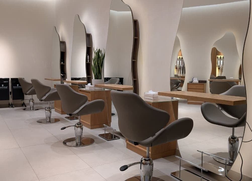 Interior view of Class and Creation Ladies Beauty Salon, Abu Dhabi, AE, featuring sleek styling stations and modern chairs.