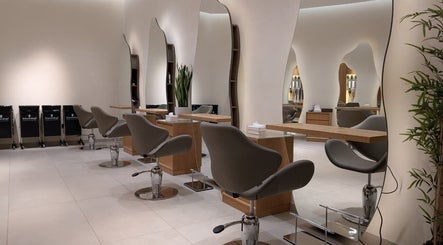 Interior view of Class and Creation Ladies Beauty Salon, Abu Dhabi, AE, featuring sleek styling stations and modern chairs.
