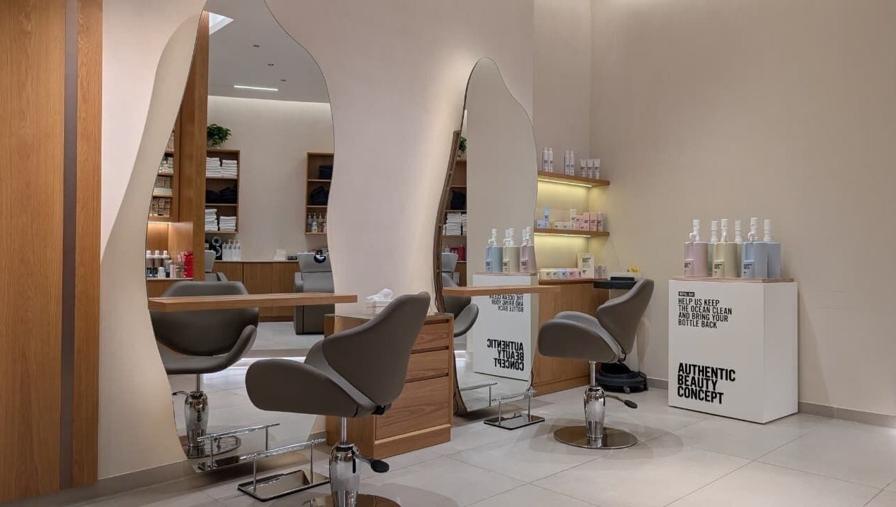 Modern salon interior at Class and Creation Ladies Beauty Salon, Abu Dhabi, AE, featuring stylish mirrors and chairs.