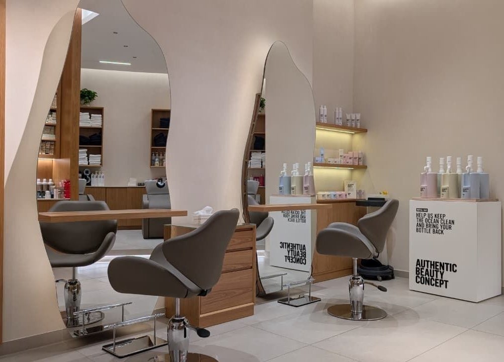 Modern salon interior at Class and Creation Ladies Beauty Salon, Abu Dhabi, AE, featuring stylish mirrors and chairs.