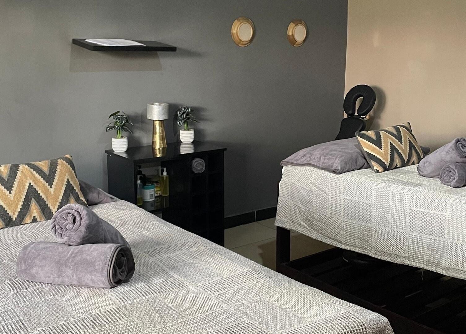 Serene massage room at Lukanda Beauty Center, Lusaka, Lusaka Province, ZM, featuring two cozy beds.