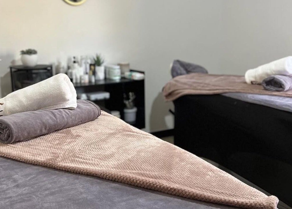 Relaxing treatment room at Lukanda Beauty Center, Lusaka, with plush towels on massage beds for ultimate wellness.