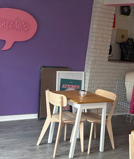 Modern seating at Canine Adventures, Seaham, England, GB, with purple and pink decor featuring Suzie's sign.