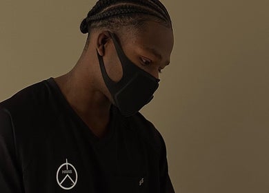 Professional at HaWB Treatment in London, England, GB, wearing a branded uniform and face mask.