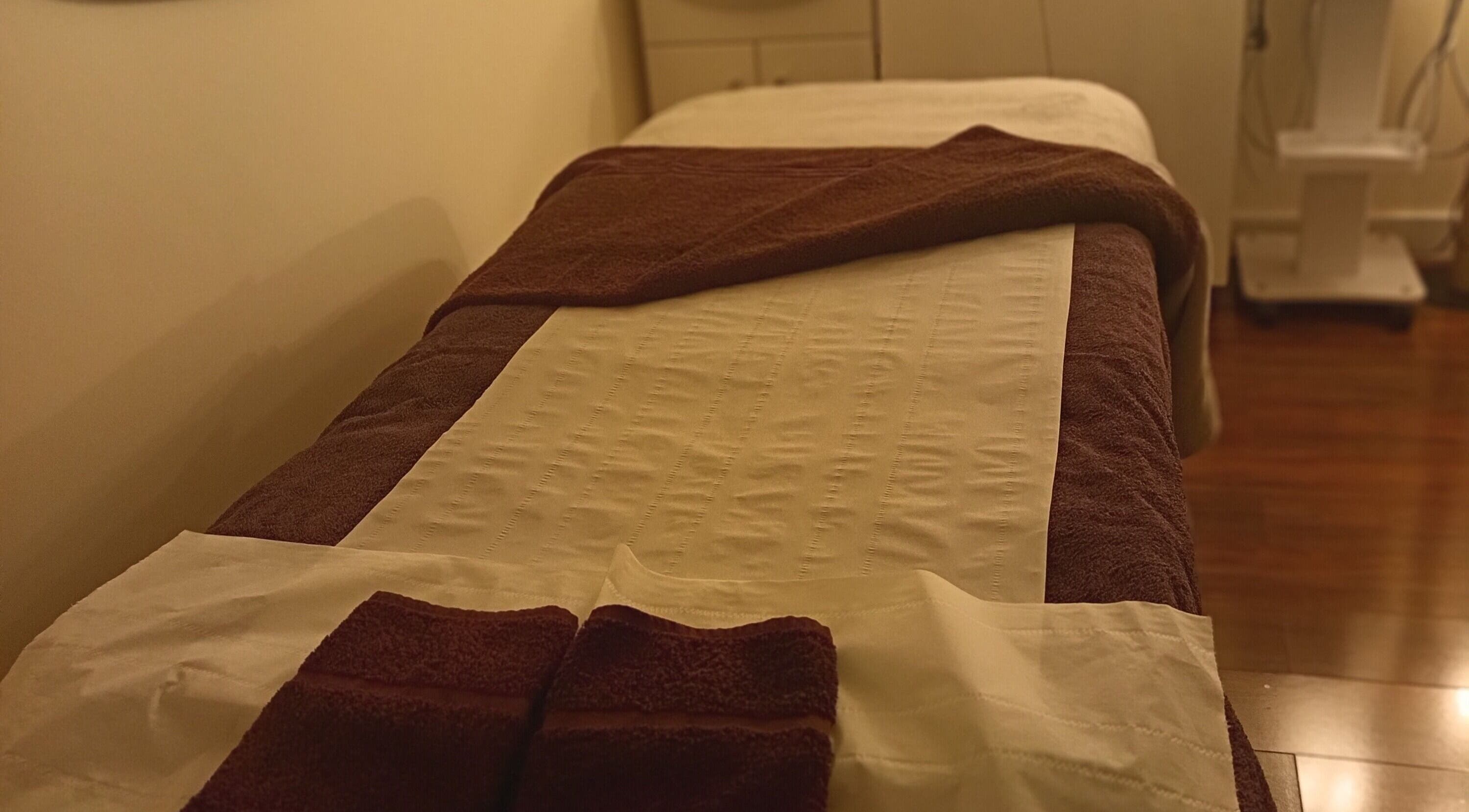 A cozy treatment room at Blissful Beauty by Becky, Coleshill, England, GB with a warmly lit massage table.