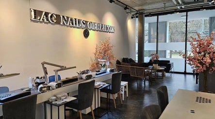Elegant interior of Lac Nails in Zürich, Zürich, CH with manicure stations and cherry blossom decor.