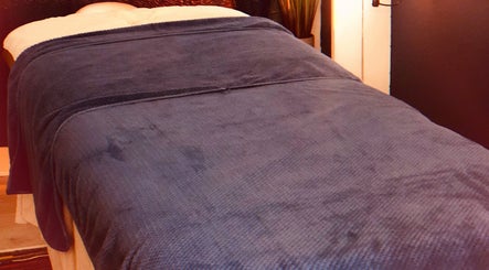 Cozy massage table at The Relaxation Station, Liss, England, GB, ready for a calming session.