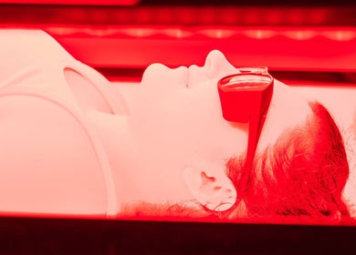 Person enjoying red light therapy at Omnia Lifestyle, London, England, GB for wellness benefits.