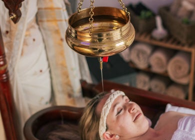 Relaxing Shirodhara therapy session at Omnia Lifestyle, London, England, GB featuring soothing oil flow.