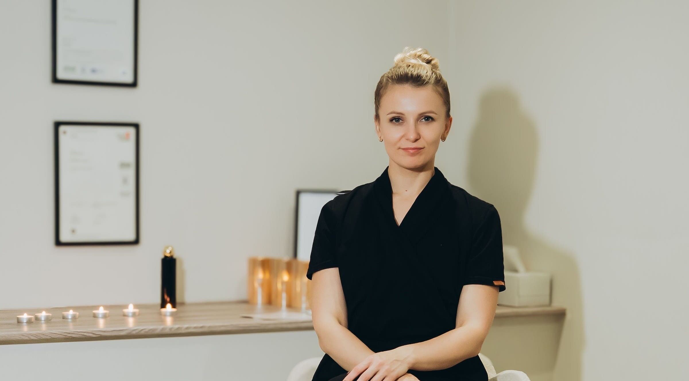 Professional therapist at Skin Ritual & Massage, Cheltenham, England, GB, ready for wellness treatments.