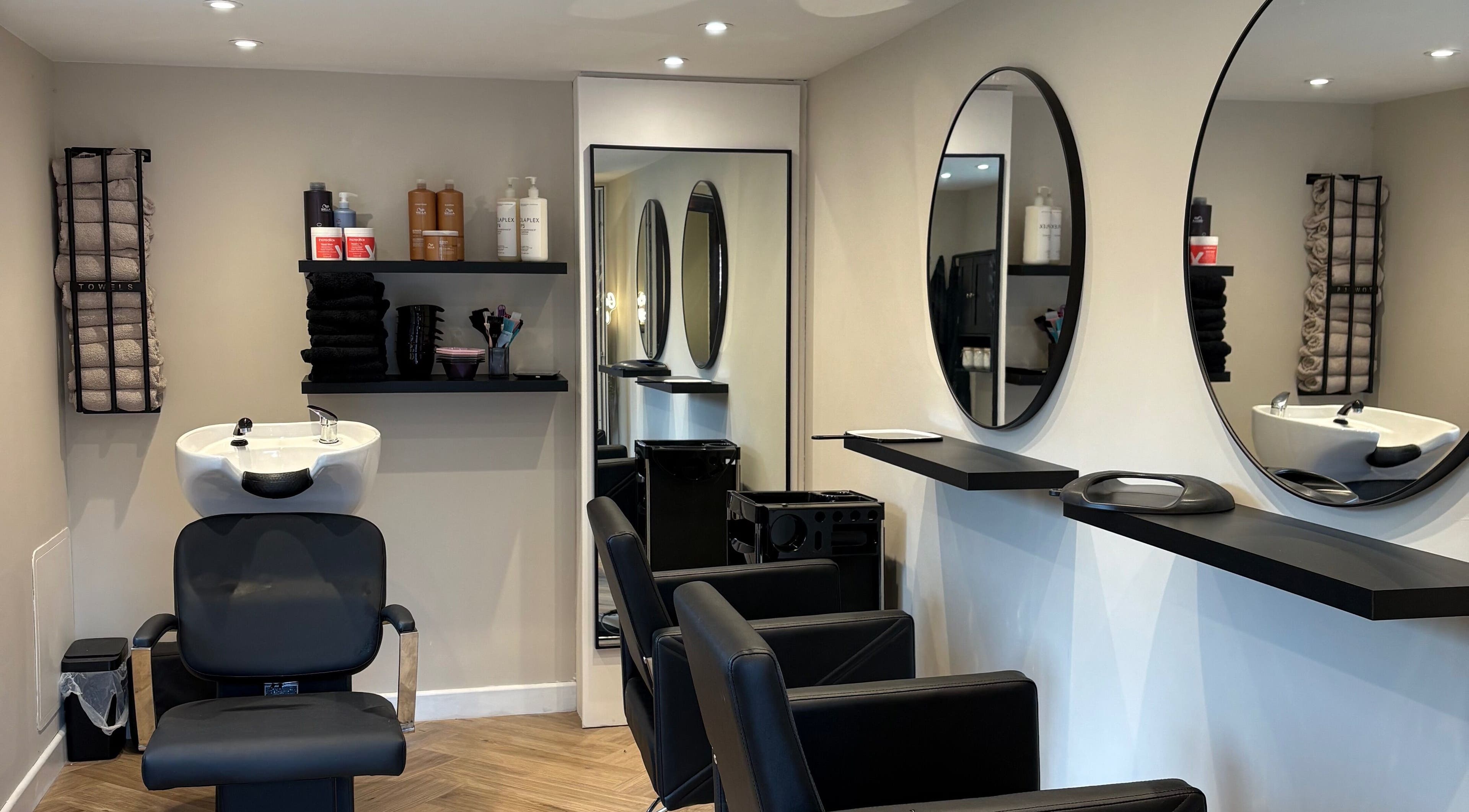 Stylish hair salon at Studio40 in Sheffield, England, GB with modern chairs and wash stations.