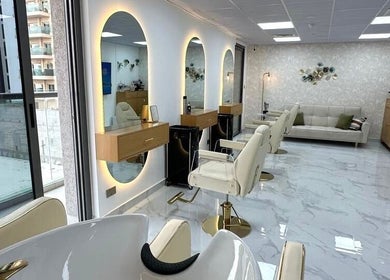 Bright interior of Bellavue Beauty Salon in Dubai, Dubai, AE with stylish mirrors and seating.