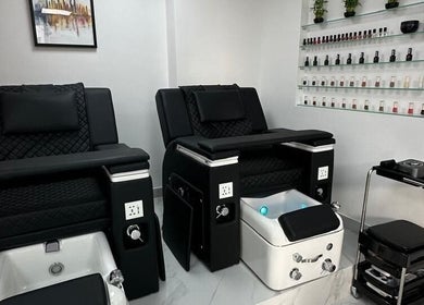 Elegant pedicure chairs in Bellavue Beauty Salon, Dubai, Dubai, AE. Stylish nail polish display enhances the ambiance.