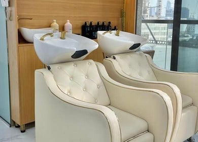 Elegant wash stations at Bellavue Beauty Salon in Dubai, Dubai, AE with plush seating and modern design.