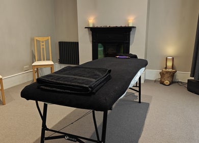Relaxing therapy room at Awaken Holistic Healing, London, England, GB, featuring a massage table and ambient lighting.