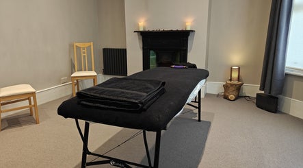 Relaxing therapy room at Awaken Holistic Healing, London, England, GB, featuring a massage table and ambient lighting.