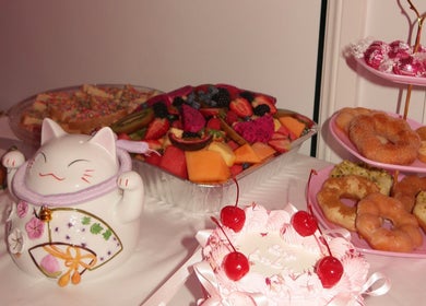 Delightful dessert spread at KLAWZ BY KAYLA, Maroubra, New South Wales, AU featuring doughnuts and fresh fruit.