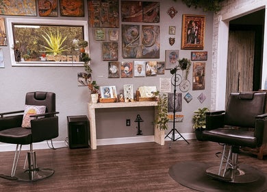 Cozy interior of Studio C by Carolyn Romero in Altamonte Springs, Florida, US with vibrant art and salon chairs.