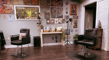 Cozy interior of Studio C by Carolyn Romero in Altamonte Springs, Florida, US with vibrant art and salon chairs.