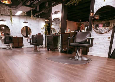 Modern salon interior at Studio C by Carolyn Romero, Altamonte Springs, Florida, US, with sleek chairs and mirrors.