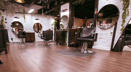 Modern salon interior at Studio C by Carolyn Romero, Altamonte Springs, Florida, US, with sleek chairs and mirrors.