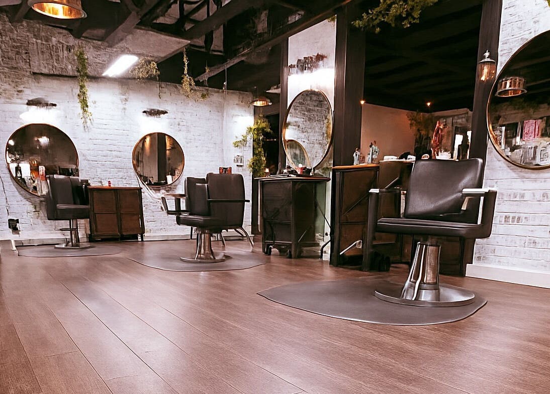Interior of Studio C by Carolyn Romero, Altamonte Springs, Florida, US with stylish salon chairs and mirrors.