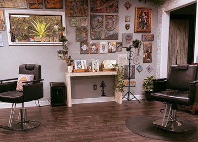 Chic salon at Studio C by Carolyn Romero, Altamonte Springs, Florida, US, featuring stylish chairs and artistic decor.