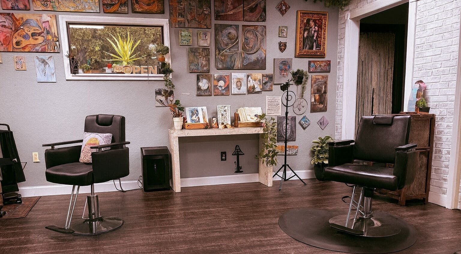 Chic salon at Studio C by Carolyn Romero, Altamonte Springs, Florida, US, featuring stylish chairs and artistic decor.