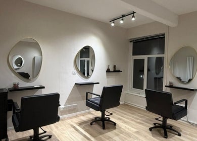Sleek salon interior at Sheffcitystylist @ Chapter Three in Sheffield, England, GB with elegant mirrors and chairs.