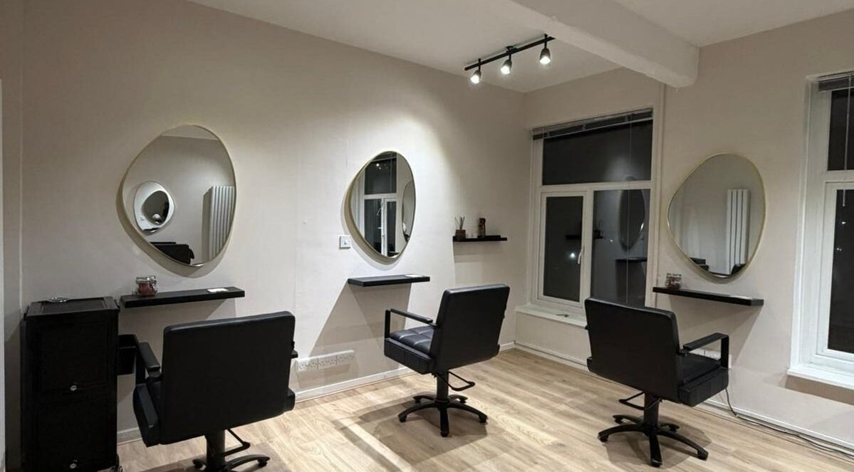 Sleek salon interior at Sheffcitystylist @ Chapter Three in Sheffield, England, GB with elegant mirrors and chairs.