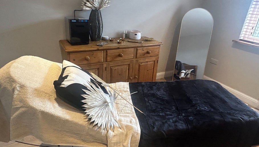 Relaxing treatment room at Skin Secrets By Jess, Park Gate, England, GB with a cozy bed and elegant decor.