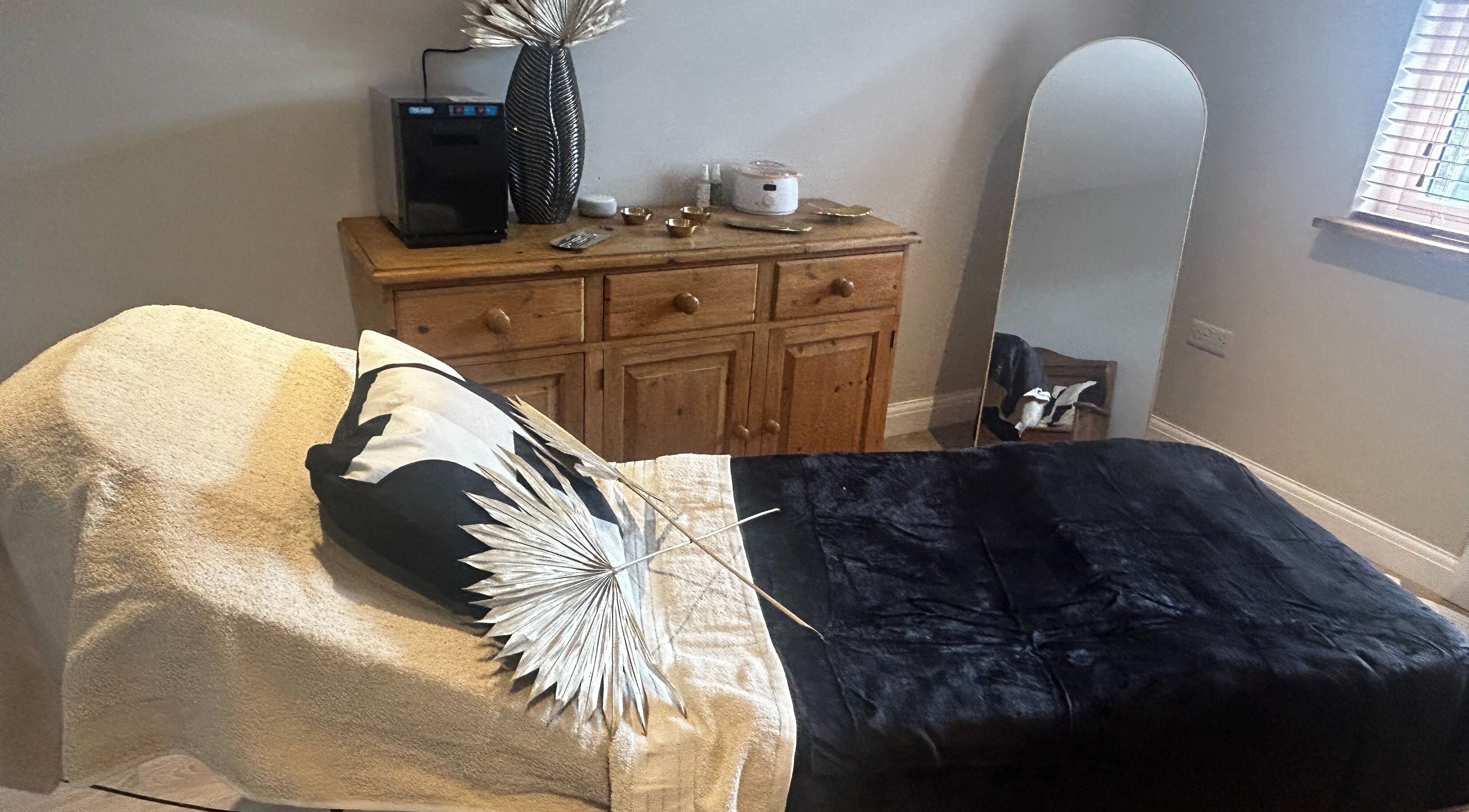 Relaxing treatment room at Skin Secrets By Jess, Park Gate, England, GB with a cozy bed and elegant decor.