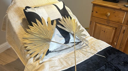 Luxurious treatment bed at Skin Secrets By Jess, Park Gate, England, adorned with golden palm decor.