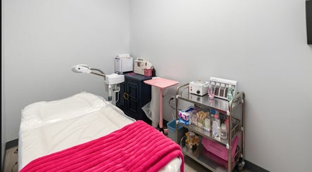 Cozy treatment room at Babe Brows Lash Lounge By Liz, Massapequa Park, New York, US with a vibrant pink blanket.