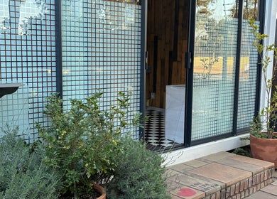 Entrance of Graceful Glow Beauty in Vanderbijlpark, Gauteng, ZA with potted plants by the door.