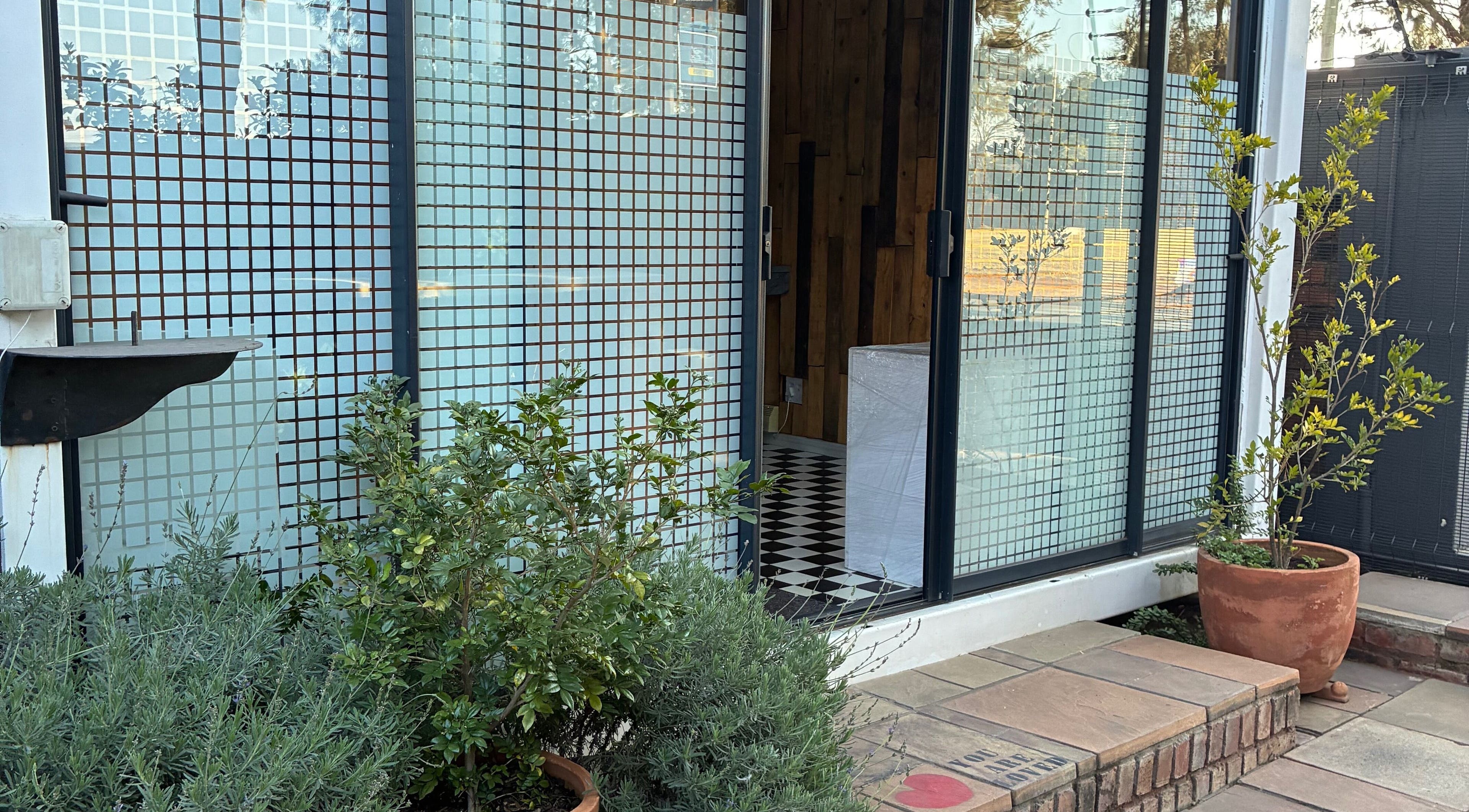 Entrance of Graceful Glow Beauty in Vanderbijlpark, Gauteng, ZA with potted plants by the door.