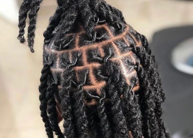 Intricate locs style at The Loc’d Shop in Nassau, New Providence, BS, showcasing expert hairstyling skills.