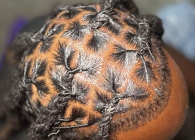 Intricate loc hairstyle at The Loc’d Shop, Nassau, New Providence, BS.