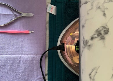 Nail prep tools at Nails_bymomo6 in Cape Town, Western Cape, ZA, featuring clippers and a nail lamp.