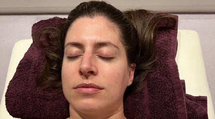 Person relaxing on plush towel at Diana Therapy, London, GB, enjoying a soothing wellness treatment.