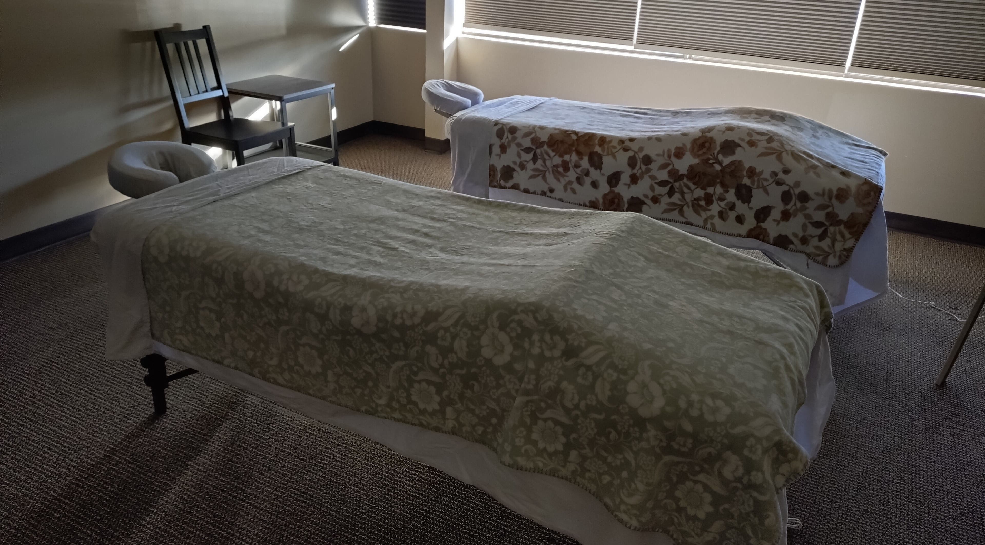 Cozy massage room with two tables at A&I Massage Solution in Spruce Grove, Alberta, CA.