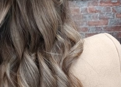 Close-up of elegant curled hair at ELEVATION HAIR 93 BY JULZ in Midrand, Gauteng, ZA.