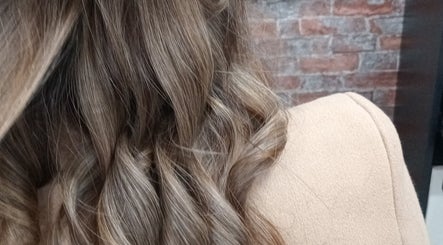 Close-up of elegant curled hair at ELEVATION HAIR 93 BY JULZ in Midrand, Gauteng, ZA.