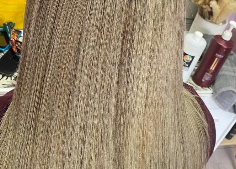 Sleek blonde hair at ELEVATION HAIR 93 BY JULZ in Midrand, Gauteng, ZA showcases expert styling.