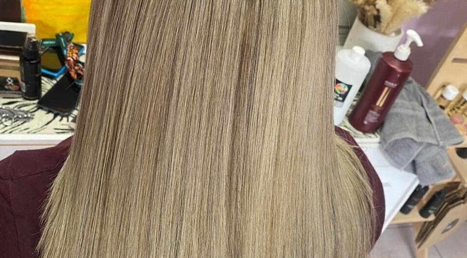 Sleek blonde hair at ELEVATION HAIR 93 BY JULZ in Midrand, Gauteng, ZA showcases expert styling.